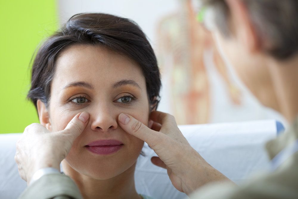 Doctor examining patient's face